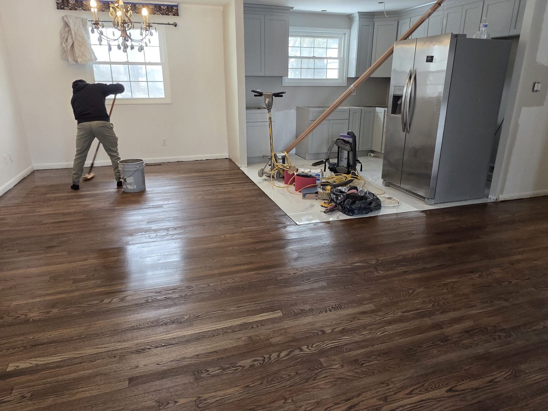Interior renovation work in progress with flooring and kitchen finish activity