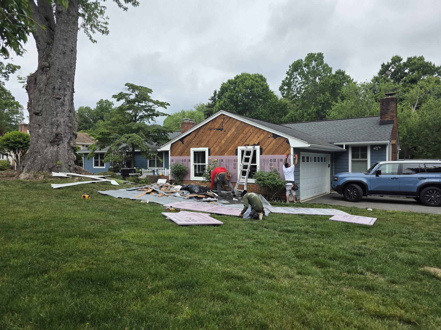 Siding and exterior renovation work in progress on a residential property