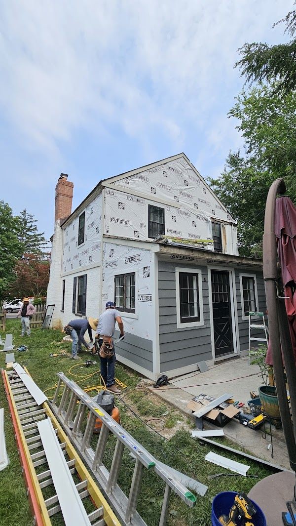 Residential siding and house wrap installation in progress